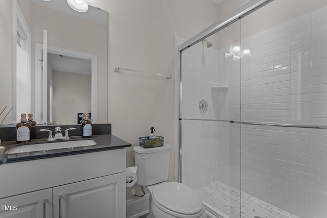 bathroom with vanity, toilet, and walk in shower