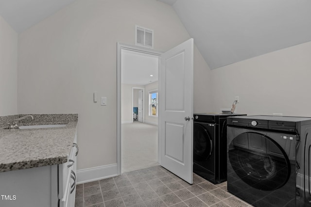 laundry room with cabinets, separate washer and dryer, and sink