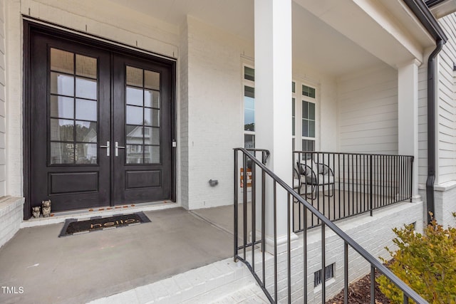 doorway to property with french doors and a porch