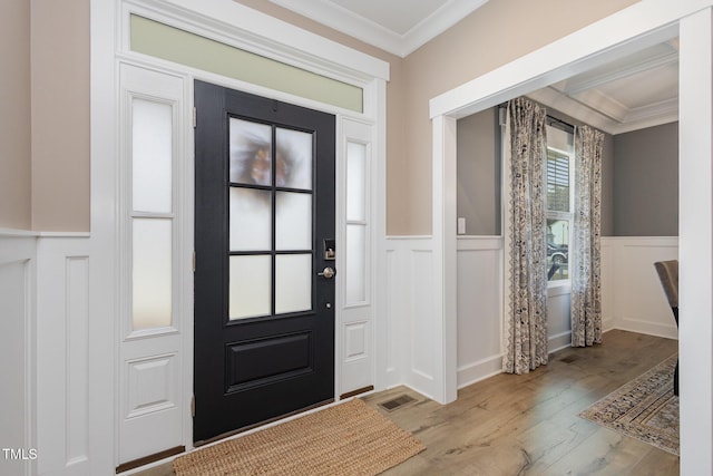 entryway featuring crown molding and light hardwood / wood-style flooring