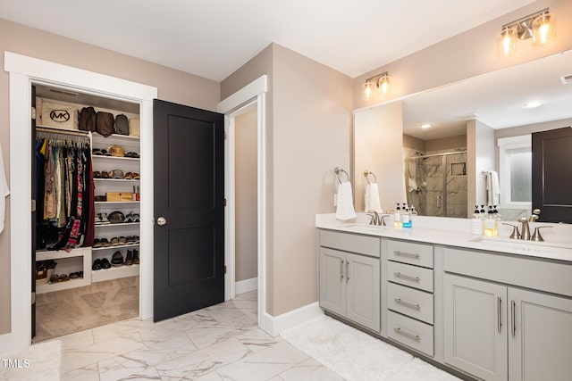 bathroom featuring vanity and a shower with door