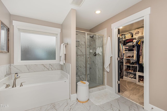 bathroom featuring independent shower and bath