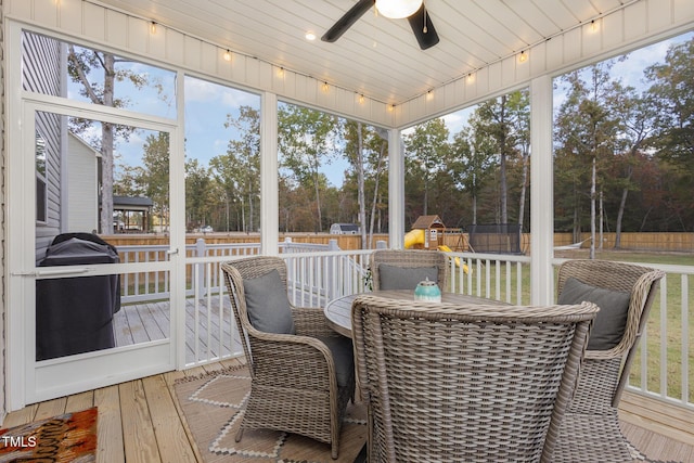 sunroom with ceiling fan and rail lighting