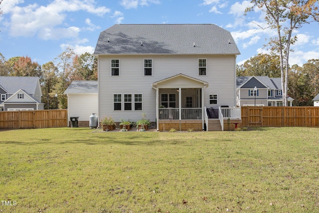 back of property featuring ceiling fan, a yard, and a sunroom