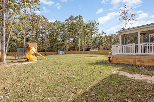 view of yard with ceiling fan and a playground