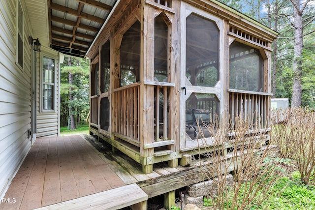 wooden deck featuring a sunroom