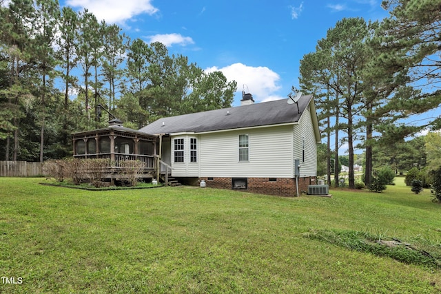 back of property featuring a yard, cooling unit, and a sunroom