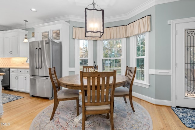 4027 Green Forest Ct, Rocky Mount, NC 27804 - dining space featuring crown molding, a healthy amount of sunlight, and light hardwood / wood-style floors