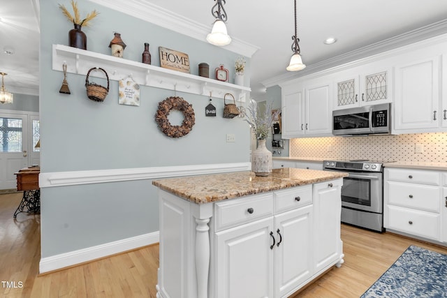 4027 Green Forest Ct, Rocky Mount, NC 27804 - kitchen featuring backsplash, stainless steel appliances, a center island, white cabinetry, and hanging light fixtures