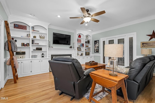 4027 Green Forest Ct, Rocky Mount, NC 27804 - living room with built in shelves, light hardwood / wood-style flooring, ceiling fan, and crown molding