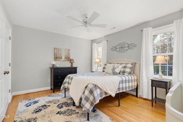 4027 Green Forest Ct, Rocky Mount, NC 27804 - bedroom featuring multiple windows, wood-type flooring, and ceiling fan