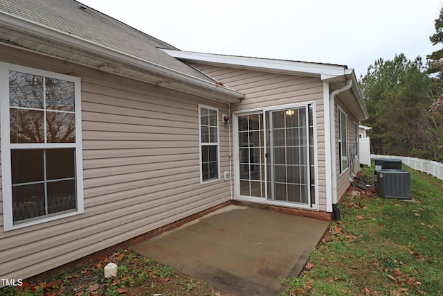 entrance to property with a patio area and central AC unit