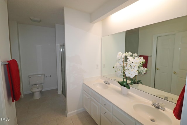 bathroom with tile patterned flooring, vanity, toilet, and a shower with door