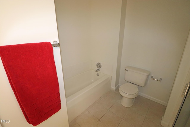 bathroom with a bathtub, tile patterned flooring, and toilet