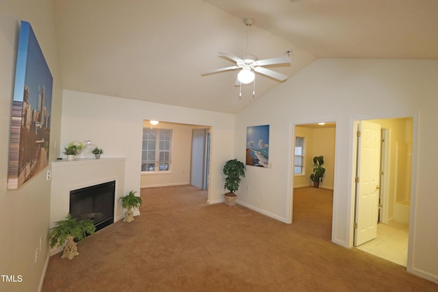 unfurnished living room featuring ceiling fan, light colored carpet, and vaulted ceiling