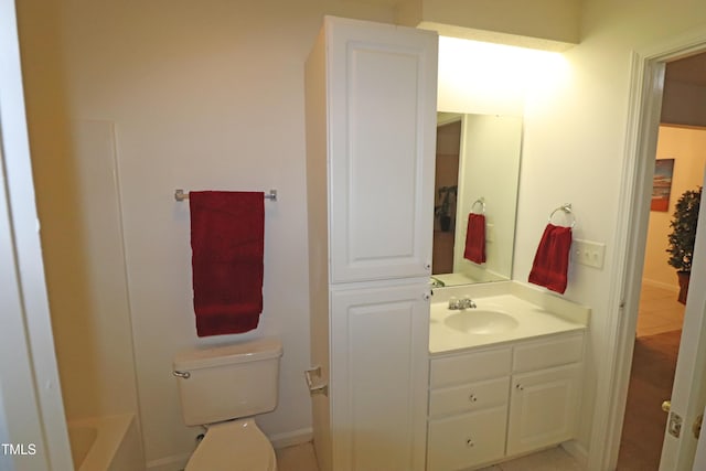 bathroom featuring tile patterned flooring, vanity, a bathtub, and toilet