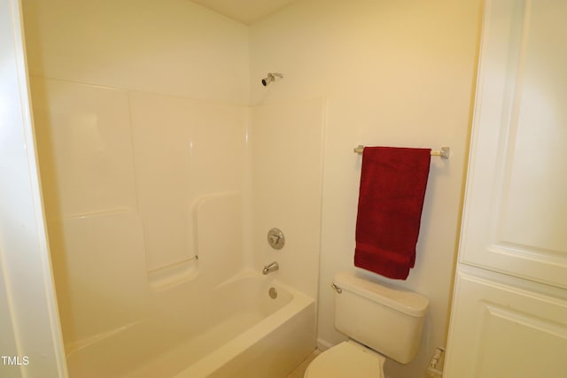 bathroom with bathtub / shower combination and toilet