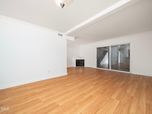 unfurnished living room featuring ornamental molding and light hardwood / wood-style flooring