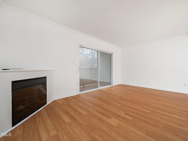 unfurnished living room with crown molding and light hardwood / wood-style floors