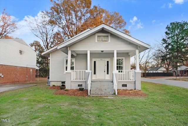 bungalow-style home with a front yard