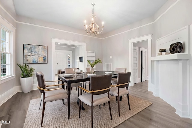 dining area featuring wood-type flooring and an inviting chandelier