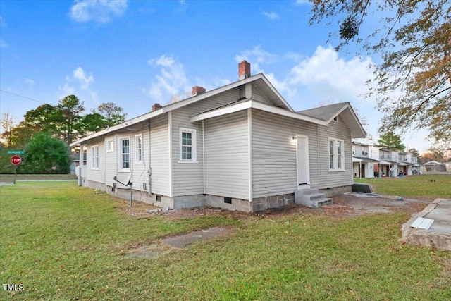 view of property exterior with a yard