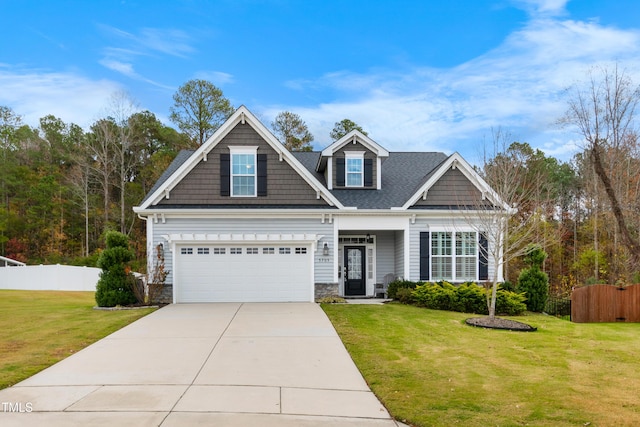 craftsman house with a front yard and a garage