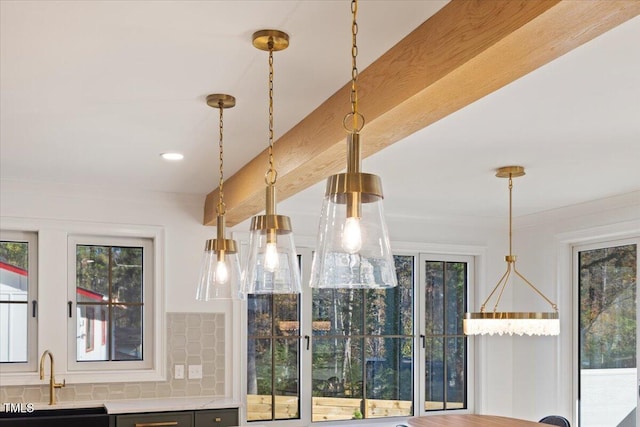 details featuring beamed ceiling, sink, pendant lighting, and backsplash