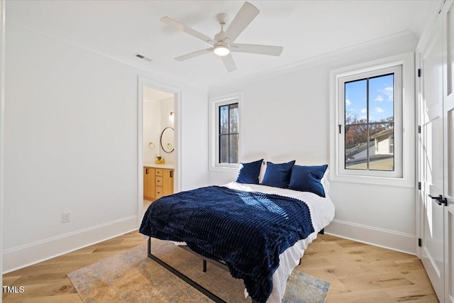 bedroom featuring ceiling fan, ensuite bathroom, light hardwood / wood-style floors, and ornamental molding