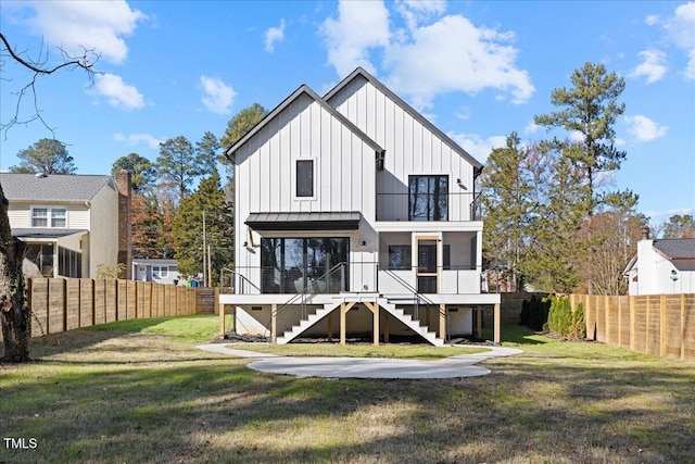 rear view of house featuring a lawn