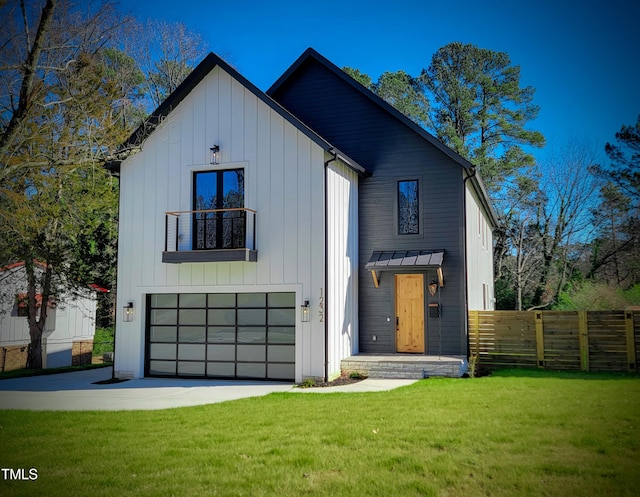 modern farmhouse with a garage and a front lawn