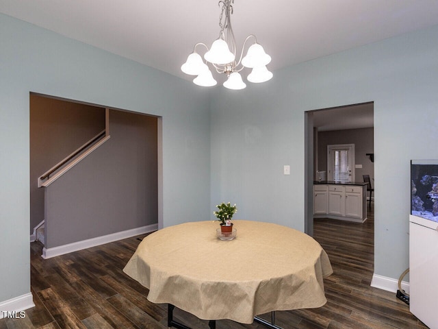 dining area featuring dark hardwood / wood-style flooring and a notable chandelier