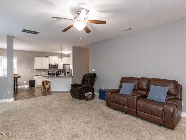 living room featuring ceiling fan and wood-type flooring