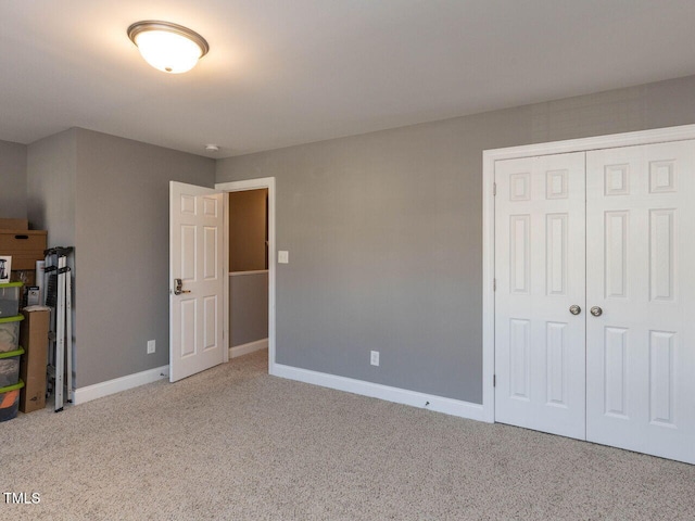 unfurnished bedroom featuring carpet flooring and a closet