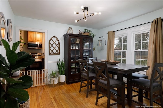 dining room featuring a chandelier and light hardwood / wood-style flooring