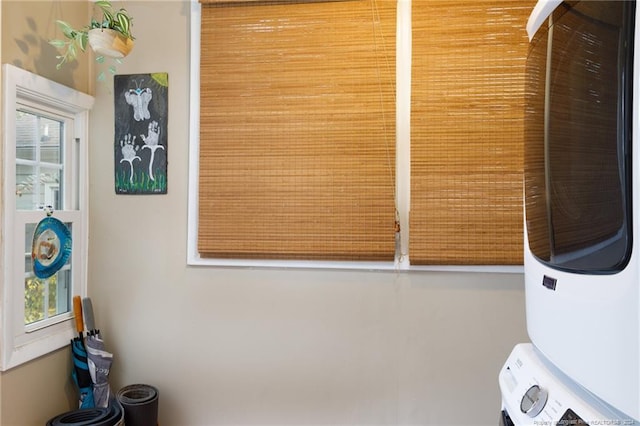 washroom with stacked washer / dryer and plenty of natural light