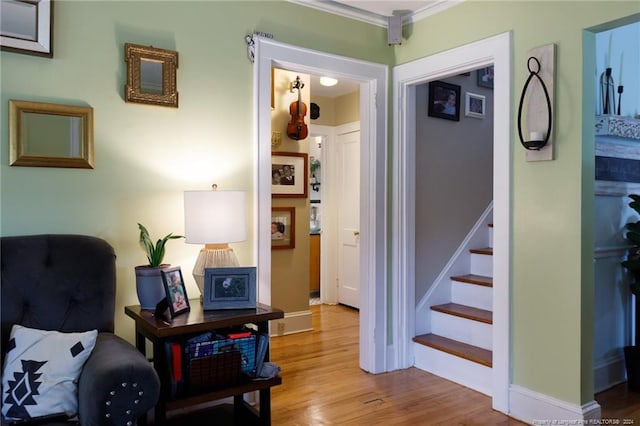 interior space with hardwood / wood-style flooring and crown molding