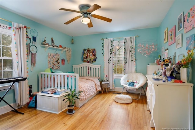 bedroom with light hardwood / wood-style floors and ceiling fan