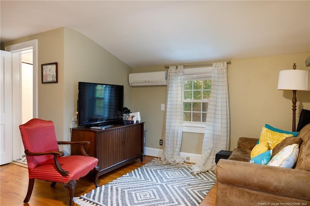 living room with a wall mounted AC, hardwood / wood-style floors, and vaulted ceiling