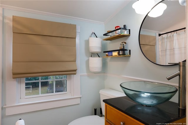 bathroom featuring toilet, vanity, vaulted ceiling, and crown molding