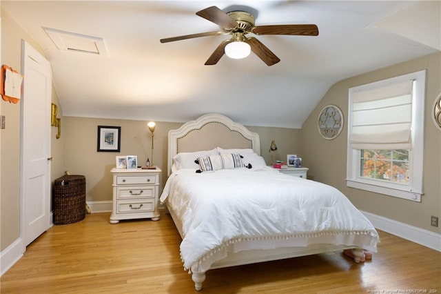 bedroom with ceiling fan, light wood-type flooring, and vaulted ceiling