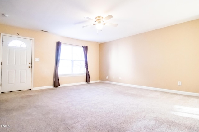 interior space featuring ceiling fan and light colored carpet