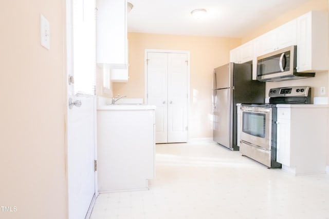 kitchen featuring white cabinets, sink, and stainless steel appliances