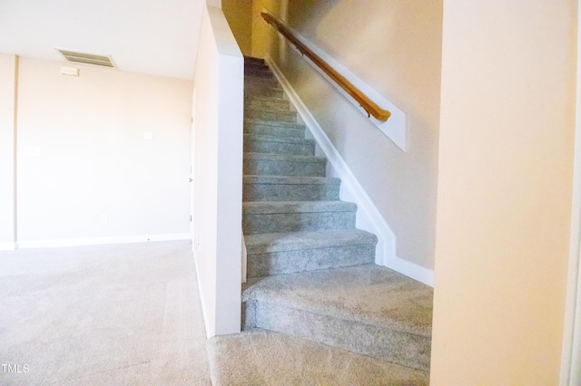 stairs featuring carpet floors