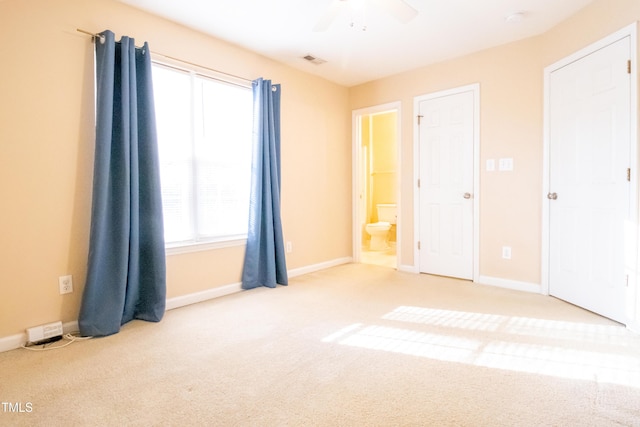 unfurnished bedroom featuring carpet, ceiling fan, and multiple windows