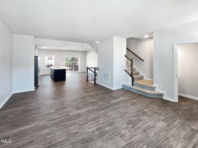 unfurnished living room featuring dark hardwood / wood-style floors