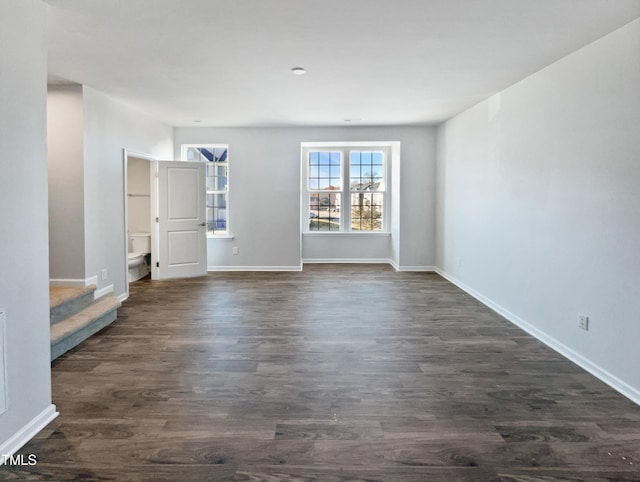 unfurnished room with dark hardwood / wood-style flooring