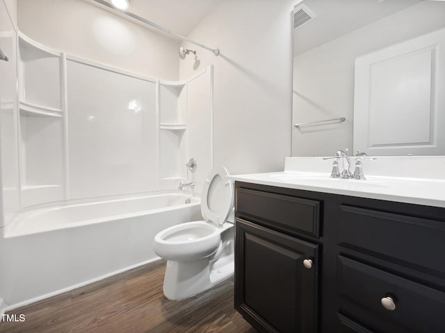 full bathroom featuring bathing tub / shower combination, hardwood / wood-style floors, vanity, and toilet