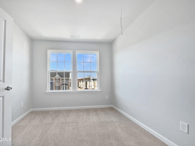 spare room with light colored carpet