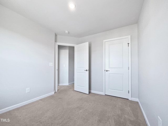 unfurnished bedroom featuring light carpet